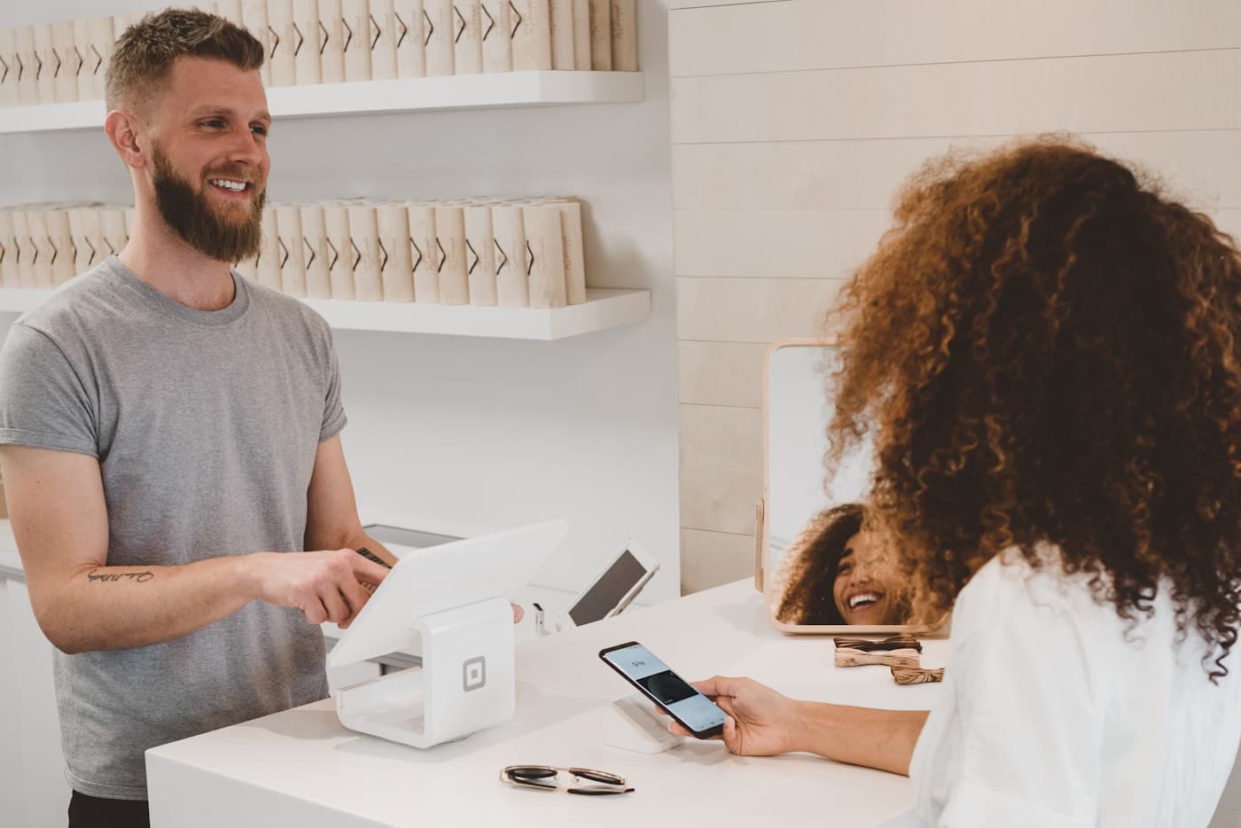 Customer paying at a local shop counter